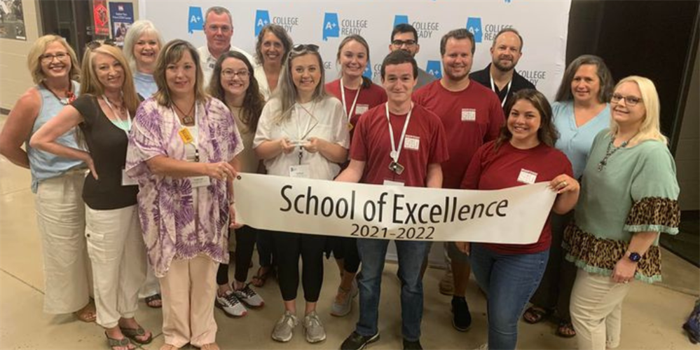 group photo of faculty/staff holding sign: School of Excellence 2021-2022 group photo of faculty/staff holding sign: School of Excellence 2021-2022